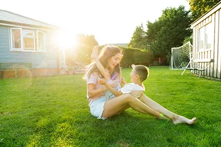 mother and son playing outside in back yard